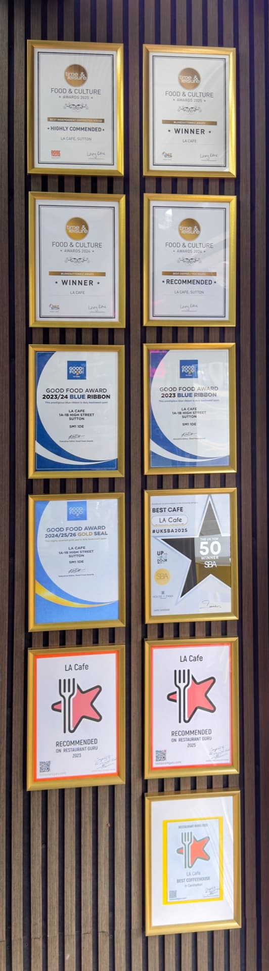 The Wall of Fame — every award LA Cafe has won, from Time & Leisure to Good Food Gold Seal