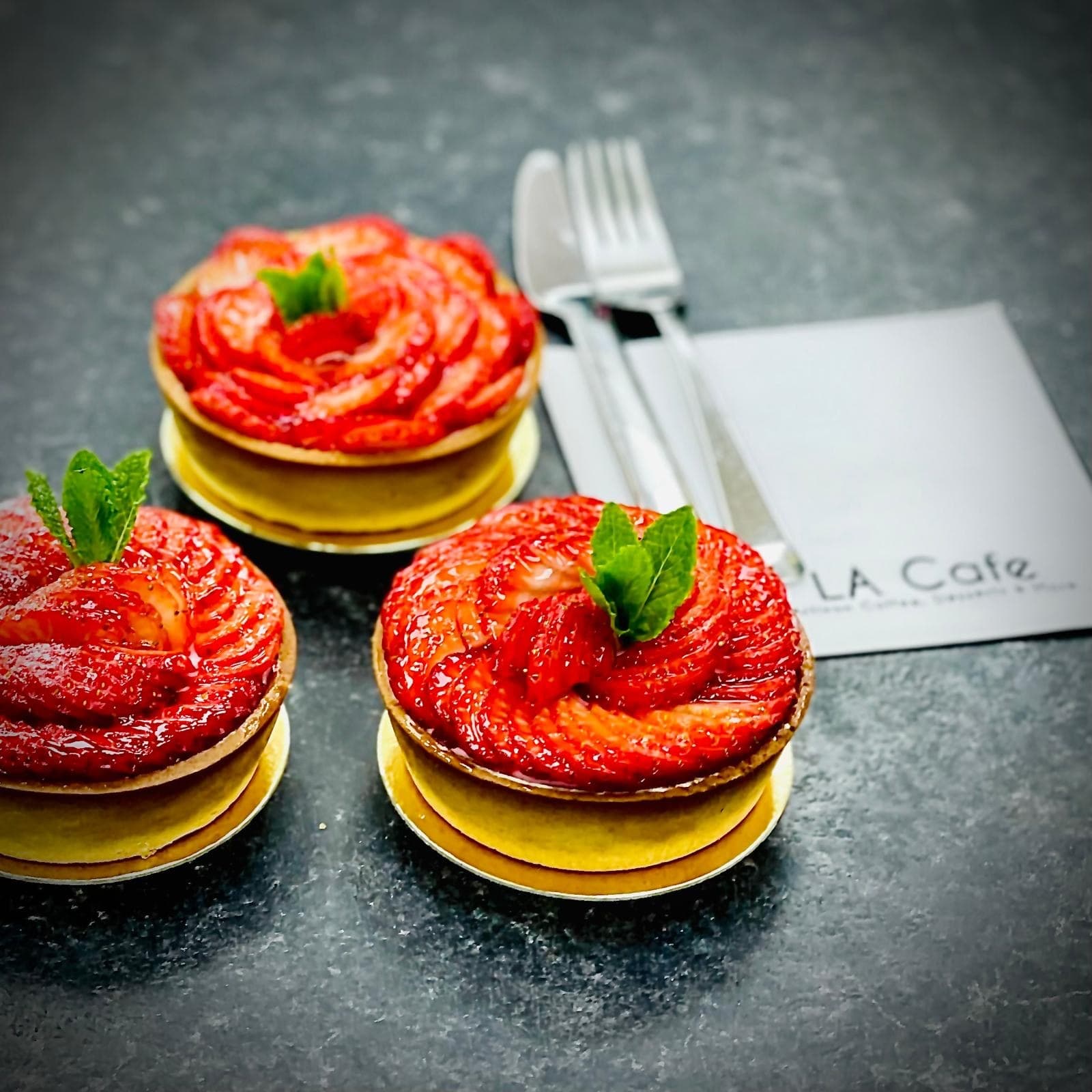 Strawberry tarts on rose petals